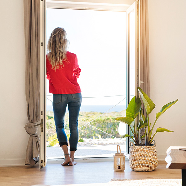 woman checking out the view from her home