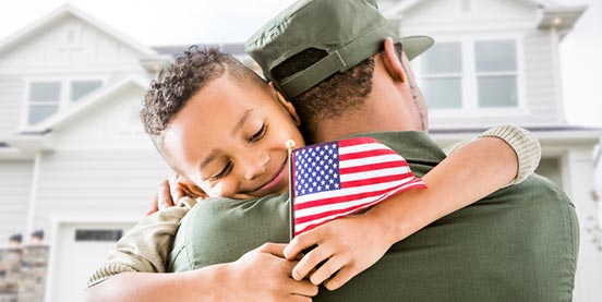 son hugging veteran dad